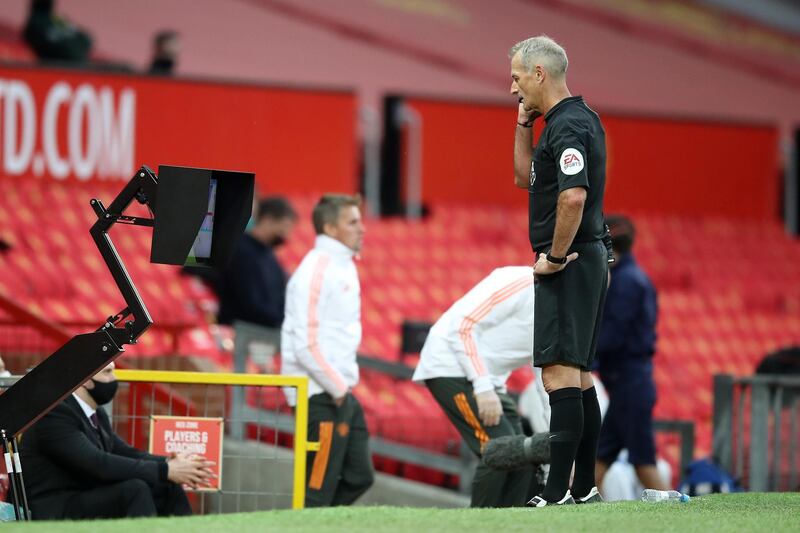 Referee Martin Atkinson checks the VAR display screen before awarding Crystal Palace a penalty. Getty