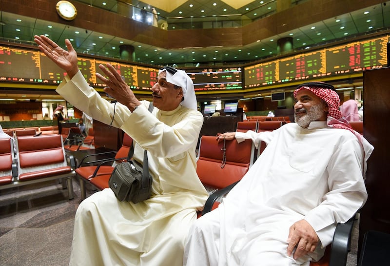 epa06639977 Kuwaiti traders react to the stock market's developments at the trading hall of the Kuwait Stock Exchange, in Kuwait City, Kuwait, 01 April 2018. Kuwait's stock exchange the same day implemented the latest set of changes aimed at attracting investors and increasing the number of initial public offerings. The Kuwait stock exchange will divide its stocks into three sections, based on criteria including their market capitalisation and the volume of shares traded.  EPA/IBRAHIM NOUFAL