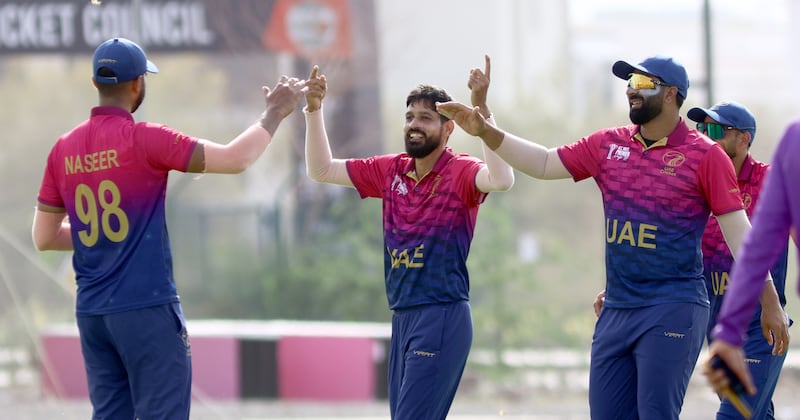 UAE's Akif Raja celebrates with teammates after taking a Cambodia wicket during their ACC Men's Premier Cup match at the Oman Cricket Stadium in Al Amerat, Muscat, on Wednesday, April 17, 2024. All photos: Subas Humagain for The National