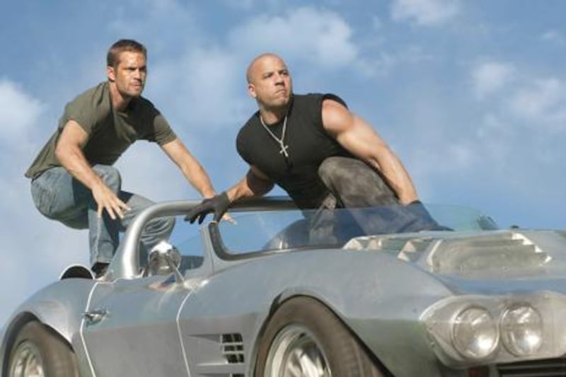Paul Walker as Brian O'Conner and Vin Diesel as Dominic Toretto in Universal Pictures' Fast Five.
