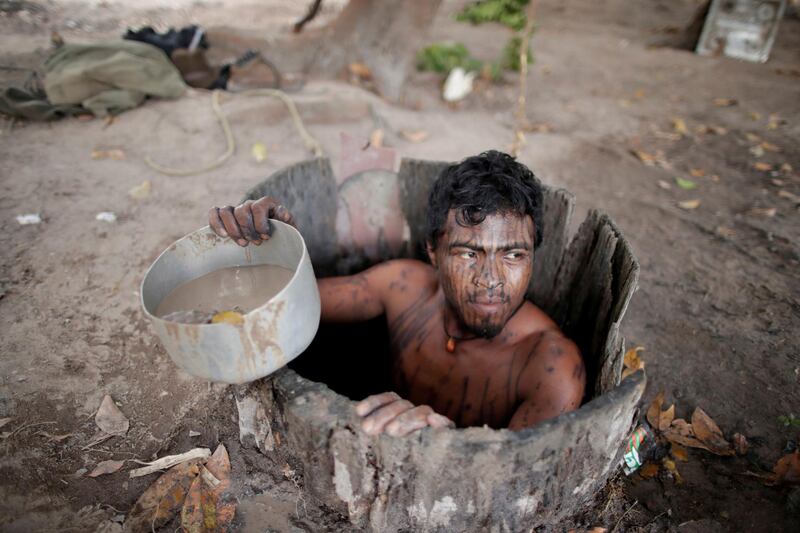 FILE PHOTO: Paulo Paulino Guajajara was hunting on Friday Nov 1 inside the Arariboia reservation in Maranhao state when he was attacked and killed by illegal loggers. He was an indigenous Indian "forest guardian," seen here drawing water from a well at a loggers camp on Arariboia indigenous land near the city of Amarante, Maranhao state, Brazil, September 11, 2019. REUTERS/Ueslei Marcelino/File Photo