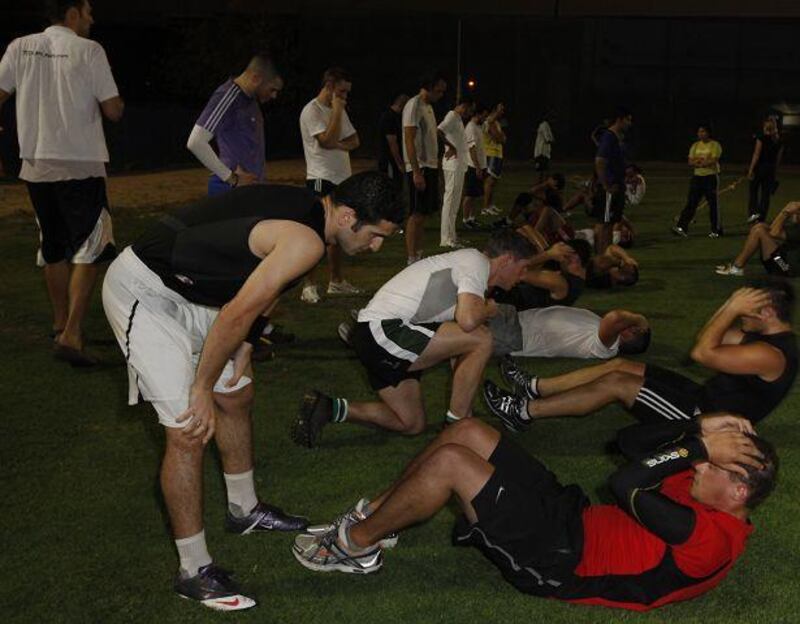 Participants of the World Record longest football match try out at the Metropolitan Hotel softball ground in Dubai.