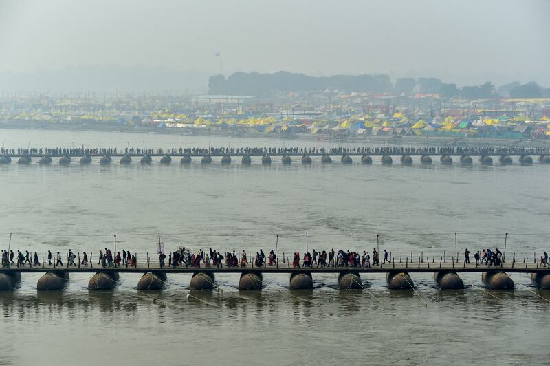 Hindus cross pontoon bridges spanning the Sangam, the confluence of the Ganges, Yamuna and Saraswati rivers, to take a holy dip to mark Mauni Amavasya, the most auspicious day, during the Magh Mela Festival in Prayagraj, India, on January 21. Reuters