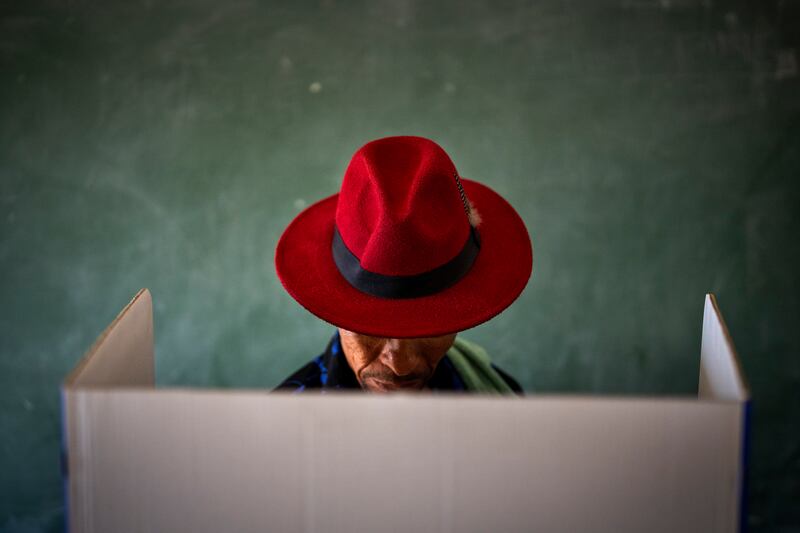 A voter fills out a ballot paper during the general election in Nkandla, Kwazulu Natal, South Africa.  AP