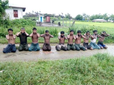 FILE PHOTO: Ten Rohingya Muslim men with their hands bound kneel in Inn Din village September 1, 2017.  To match Special Report MYANMAR-JOURNALISTS/TRIAL     Handout via REUTERS/File Photo
