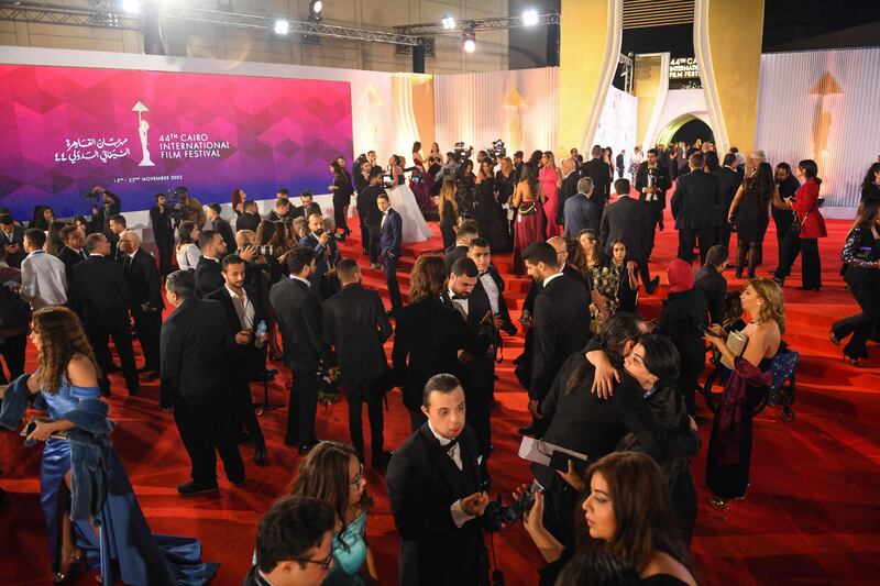 Attendees gather on the red carpet.