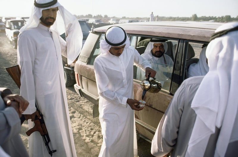 UNITED ARAB EMIRATES - JANUARY 01:  Body guards pour coffee for a sheikh at a camel race, Adh Dhayd, Sharjah, United Arab Emirates  (Photo by Steven L. Raymer/National Geographic/Getty Images)