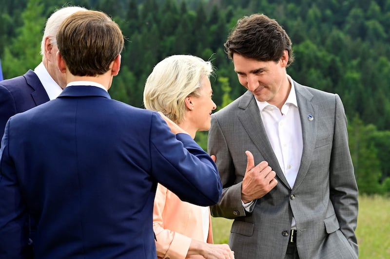 Ms von der Leyen chats with Mr Trudeau. AFP
