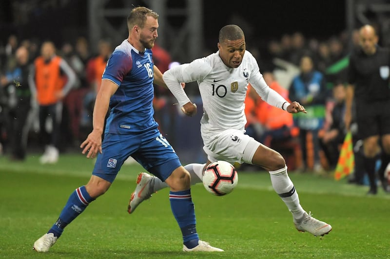 France's forward Kylian Mbappe (R) vies with Iceland's midfielder Runar Mar Sigurjonsson during the friendly football match between France and Iceland at the Roudourou Stadium in Guingamp, western France. AFP