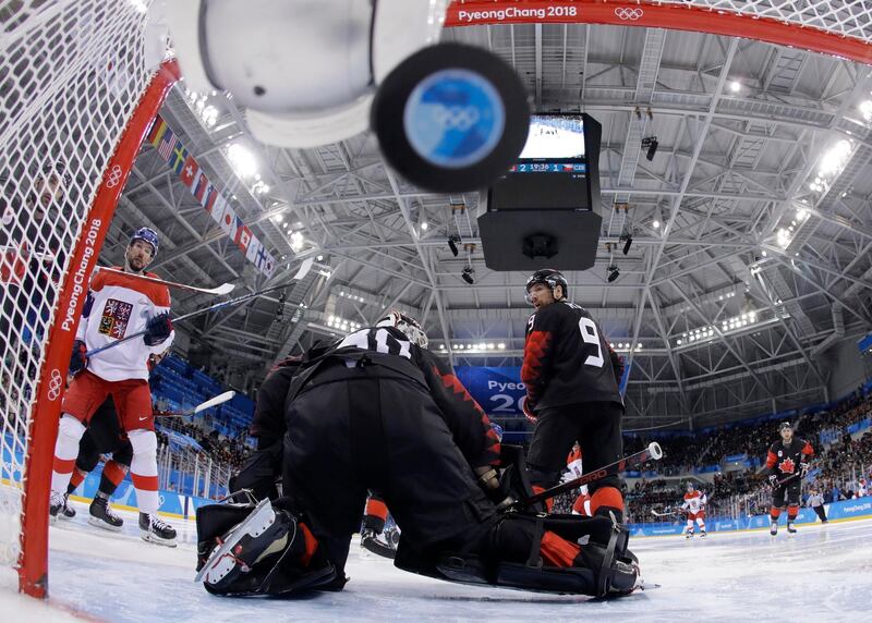 The puck shot by Michal Jordan (47), of the Czech Republic, flies past Ben Scrivens (30), of Canada, for a goal during the second period of the preliminary round of the men's hockey game at the 2018 Winter Olympics in Gangneung. Matt Slocum / AP Photo