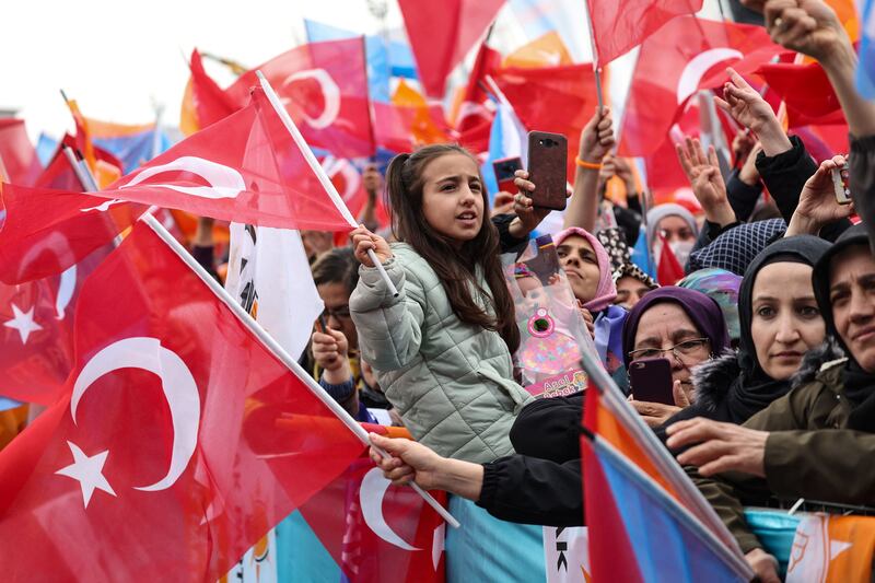 Supporters of Mr Erdogan wave Turkish flags at the Ankara rally. AFP