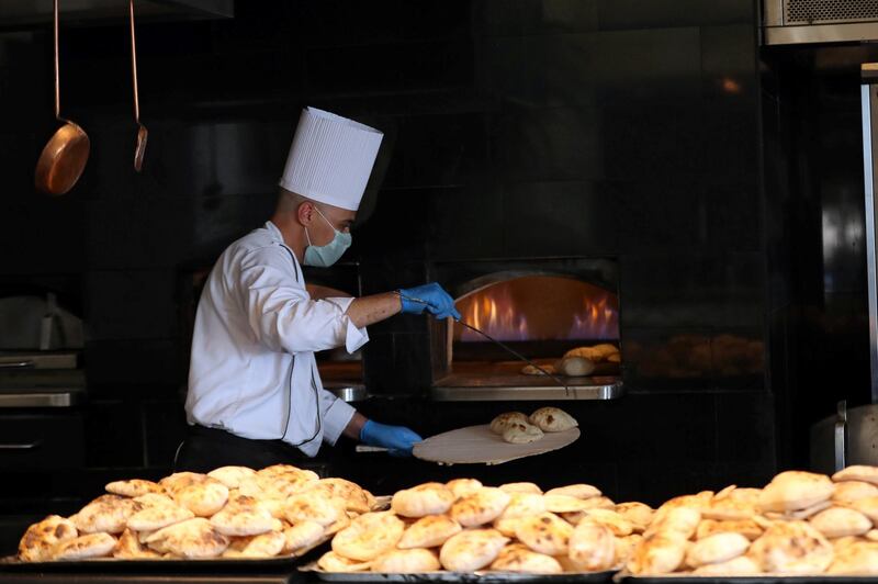 A chef bakes bread at Conrad, one of the hotels in Egypt that received a stamp of approval to reopen in Cairo.  REUTERS