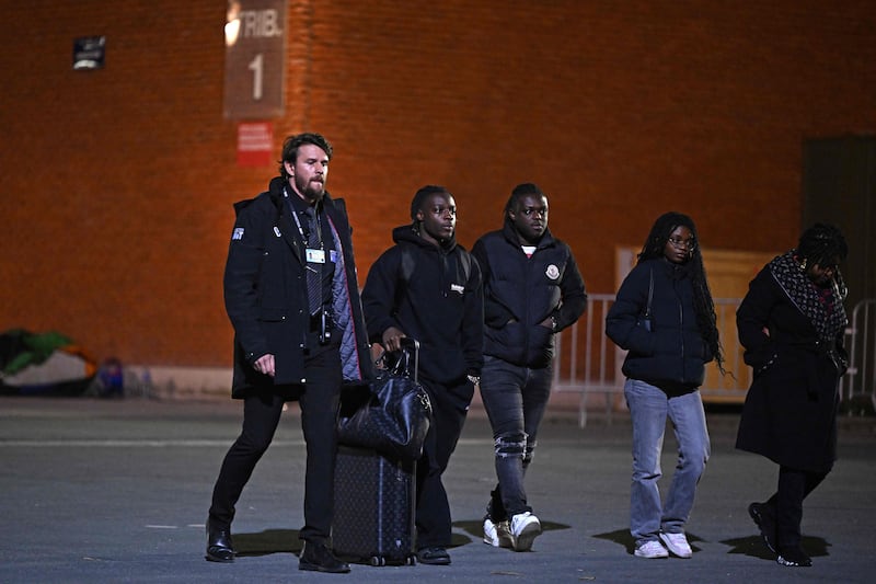 Belgian midfielder Jeremy Doku, second from left, leaves. AFP