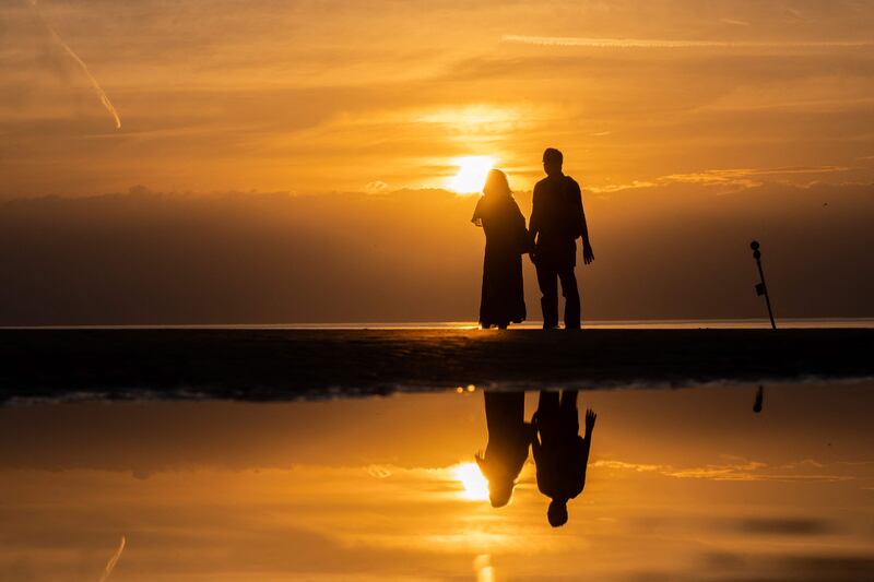 People watch the sunset on the beach of Deauville on the sidelines of the 48th Deauville US Film Festival. AFP