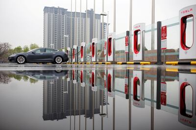 FILE PHOTO: A Tesla car pictured at a charging point in Beijing, China, April 13, 2018. REUTERS/Thomas Peter/File Photo