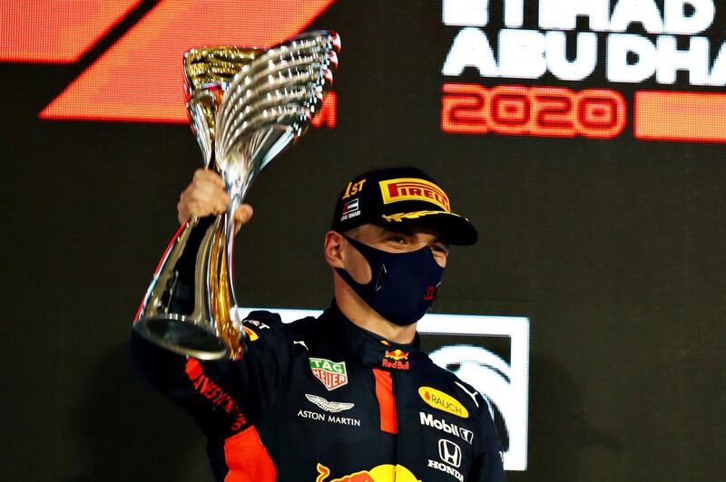 ABU DHABI, UNITED ARAB EMIRATES - DECEMBER 13: Race winner Max Verstappen of Netherlands and Red Bull Racing celebrates on the podium during the F1 Grand Prix of Abu Dhabi at Yas Marina Circuit on December 13, 2020 in Abu Dhabi, United Arab Emirates. (Photo by Mark Thompson/Getty Images)