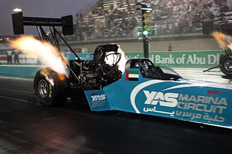 Tommy Johnson Jr, the American driver, in action in his Top Fuel Dragster against fellow American Rod Fuller during the Yas Drag Racing Festival at the Yas Marina circuit, Abu Dhabi yesterday.