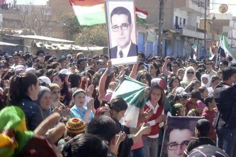 Demonstrators hold up a poster of the assassinated Kurdish leader Meshaal Tammo during a protest against Syria's President Bashar Al Assad in Qamishli in March 2012. He was assassinated a year ago - a major blow to the opposition movement in Syria.