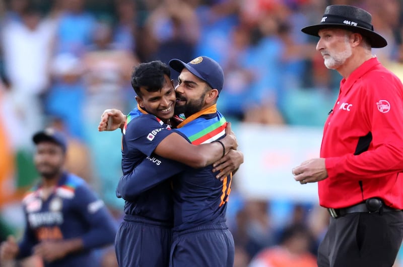 India's captain Virat Kohli congratulates pacer Thangarasu Natarajan after taking the wicket of Australia's D'Arcy Short in Sydney. AFP