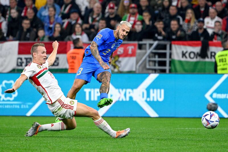 Italy's Federico Dimarco, right, in action against Hungary's Adam Lang. AP