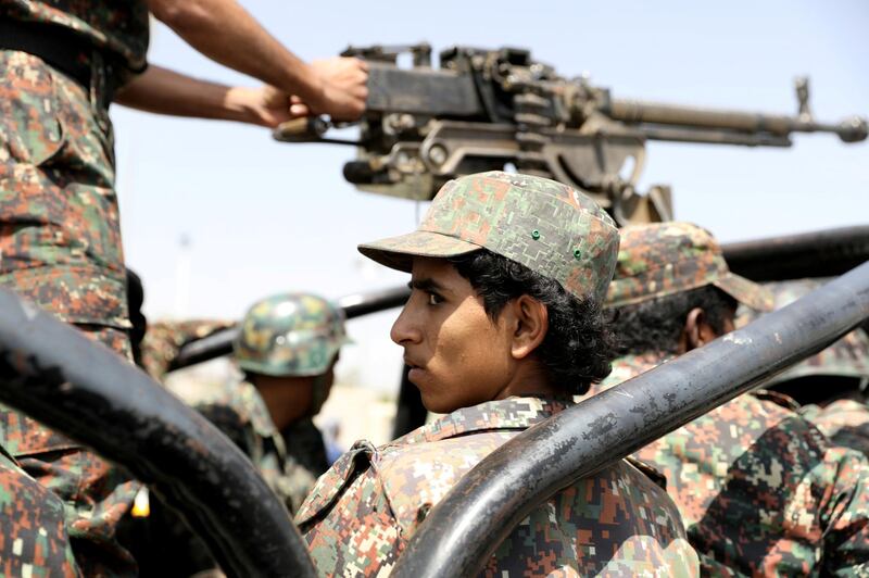 FILE PHOTO: A police trooper rides on the back of a patrol truck during the funeral of Houthi fighters killed during recent battles against government forces, in Sanaa, Yemen September 22, 2020. REUTERS/Khaled Abdullah/File Photo