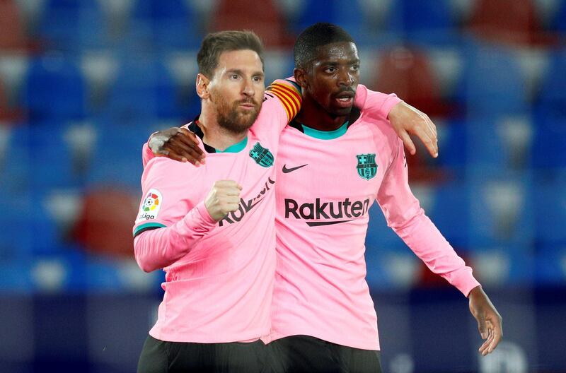 Messi (L) celebrates with teammate Ousmane Dembele after scoring the first. EPA