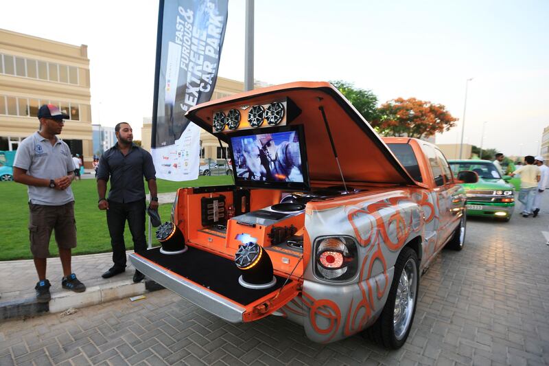 Dubai, May 31, 2013 - Jassem Al Sumaiti (right) stands with his custom 2001 Chevrolet Silverado at the Fast and Furious "Extreme Car Park" event at Studio City in Dubai, May 31, 2013. (Photo by: Sarah Dea/The National)

