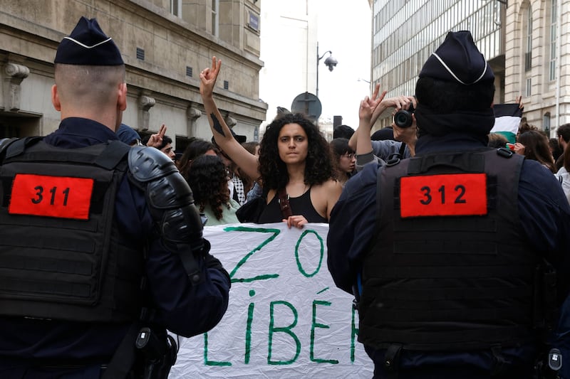 A protester make a victory sign during a rally in support of Palestinians at the Sorbonne University in Paris on April 29, 2024.  Students gathered at midday on April 29, 2024 at the Sorbonne to express their support for the Palestinians in front of the building and inside the university, where they set up tents, following the similar action at Sciences Po of April 26, 2024, a day of blockades and mobilisation, marked by tensions.  (Photo by Geoffroy VAN DER HASSELT  /  AFP)
