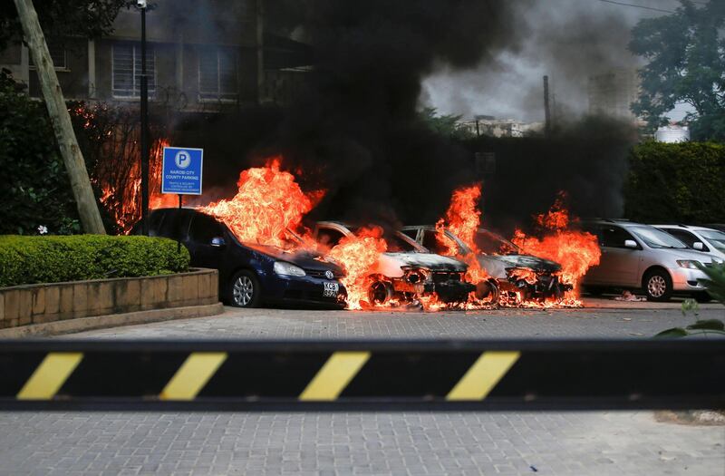 Burning cars are seen at the scene where explosions and gunshots were heard at the Dusit hotel compound, in Nairobi, Kenya January 15, 2019. REUTERS/Baz Ratner