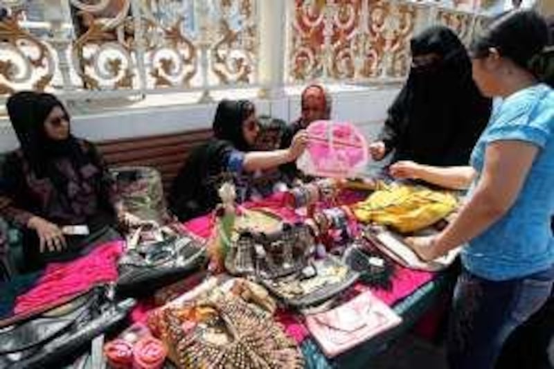 SHARJAH, UNITED ARAB EMIRATES – Oct 10: Left to Right-  Azza Alaskar and Nuha Asad at their stall in the Flea market organized at Al Qasba in Sharjah. (Pawan Singh / The National) For News. Story by Leah *** Local Caption ***  PS1010-FLEA MARKET06.jpg