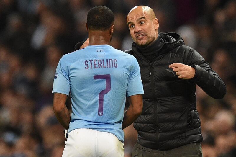 Manchester City manager Pep Guardiola gives instructions to Raheem Sterling. AFP