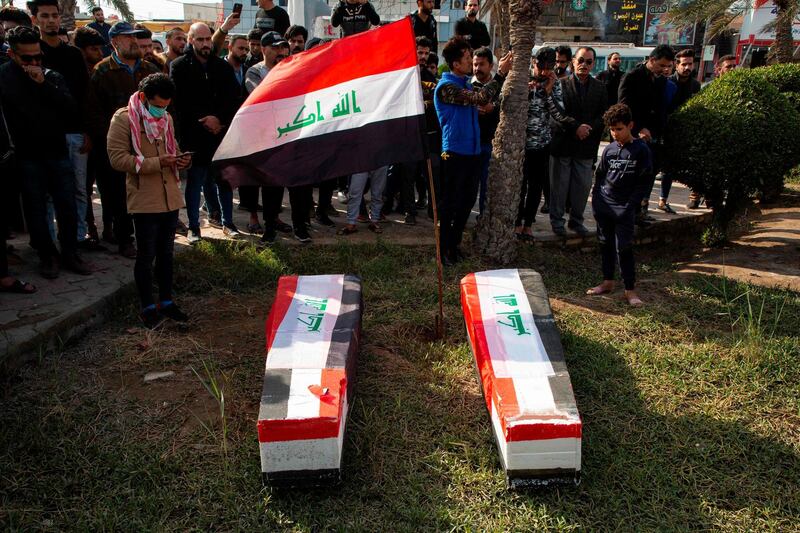 Iraqis carry mock coffins as they take part in a rally to mourn Ahmad Abdessamad, a correspondent for local television station Al-Dijla, and his cameraman Safaa Ghali were shot dead late Friday in Basra. AFP