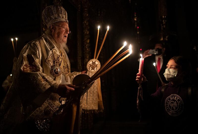 Ecumenical Patriarch Bartholomew I, the spiritual leader of the world's Orthodox Christians, holds candles as he conducts an Easter service at the Patriarchal Cathedral of St George in Istanbul. AP