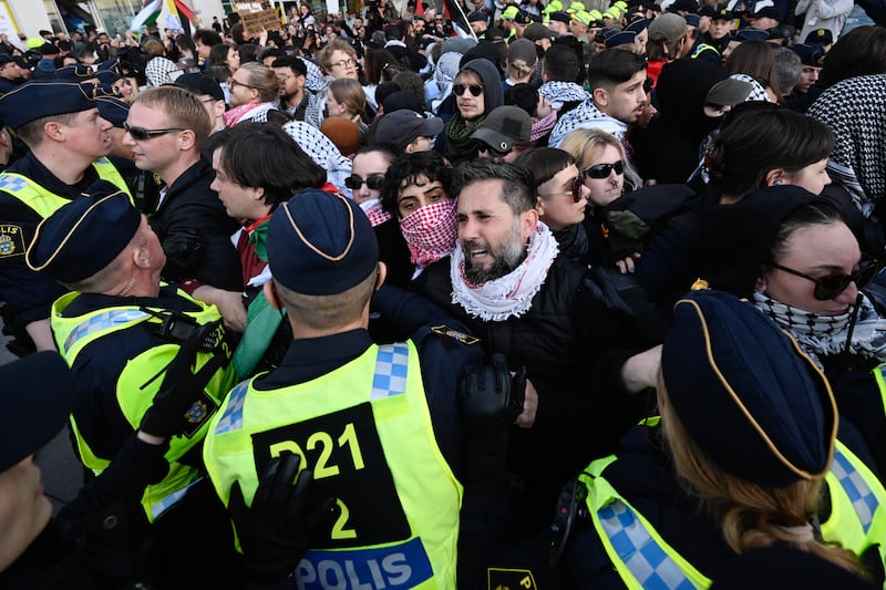 Pro-Palestine protesters face police officers outside Malmo Arena where the 68th Eurovision Song Contest was staged. EPA