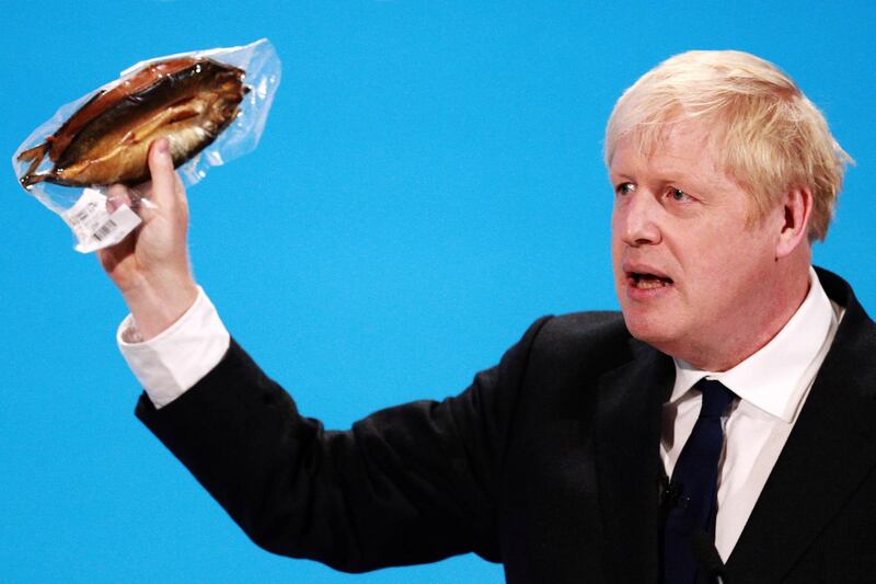 LONDON, ENGLAND - JULY 17: Boris Johnson holds a kipper (smoked fish) to help illustrate a point as he talks at the final hustings of the Conservative leadership campaign at ExCeL London on July 17, 2019 in London, England. Boris Johnson and Jeremy Hunt are the remaining candidates in contention for the Conservative Party Leadership and thus Prime Minister of the UK. Results will be announced on July 23rd 2019. (Photo by Dan Kitwood/Getty Images)