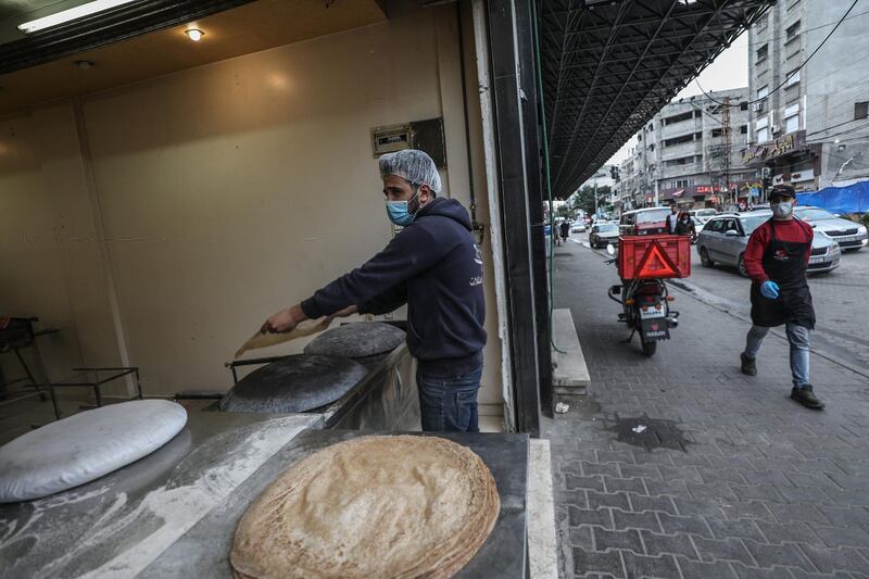 A bakery worker wears a facemask during his work at the family bakery as a precaution against the spread of the Covid-19 coronavirus in Gaza City. EPA