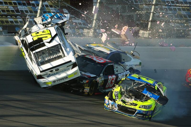 Parker Kligerman, No 30, goes airborne on February 19, 2014, in a crash with Ryan Truex, No 83, Paul Menard, No 27, and Dave Blaney, No 77, during practice for Sunday’s Nascar Daytona 500 Sprint Cup Series race in Daytona Beach, Florida, US. Nigel Cook / AP photo/News-Journal