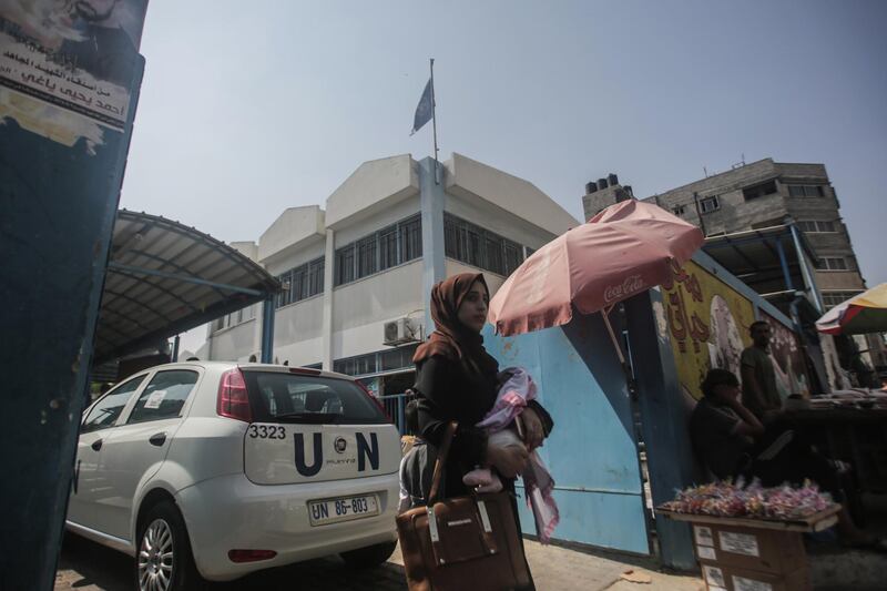 Palestinians refugees wait at an UNRWA clinic to receive a free medical check-up from teams in Gaza City. EPA