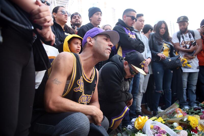 Fans place flowers, candles and memorabilia  during a vigil for late Los Angeles Lakers guard Kobe Bryant, at the LA Live entertainment complex across the street from the Staples Center, home of the Los Angeles Lakers, in Los Angeles, California.  EPA