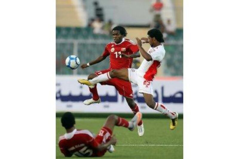 Oman’s Saeed al Mreighi, left, vies for the ball with UAE’s Maher Galoum in Aden yesterday.