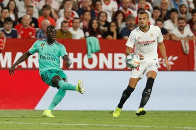 Real Madrid's Ferland Mendy, left, is challenged by Sevilla's Joan Jordan during the Spanish La Liga soccer match between Sevilla and Real Madrid at the Ramon Sanchez Pizjuan stadium in Seville, Spain, Sunday, Sept. 22, 2019. (AP Photo/Miguel Morenatti)