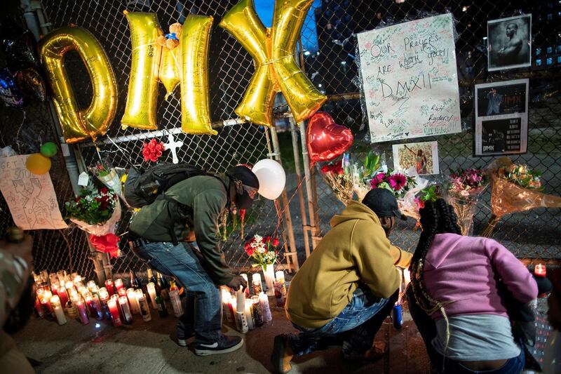 Fans light candles at a makeshift memorial for musician and actor DMX outside White Plains Hospital, after he died at the age of 50 in White Plains, New York, U.S., April 9, 2021. REUTERS/Eduardo Munoz