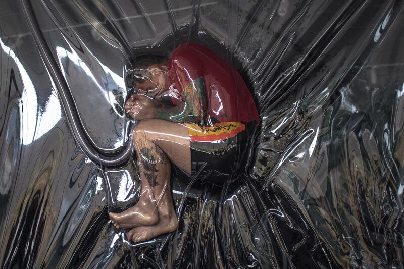 A performer inside an artwork installation Shrink during an art exhibition 'Lawrence Malstaf: Extra' at IMS of Modern Artland, in Beijing, China. EPA