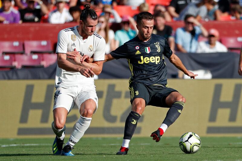 Juventus' Miralem Pjanic and Real Madrid's Gareth Bale battle for the ball. Reuters