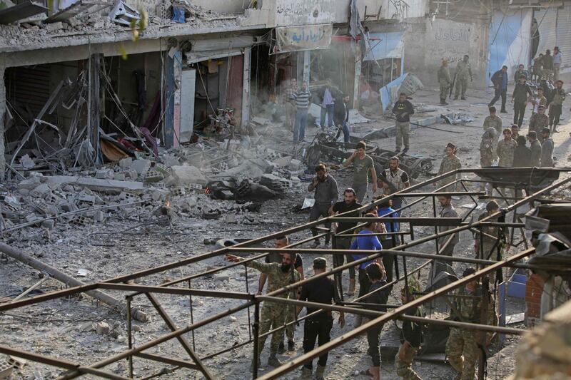 Turkey-backed Syrian fighters inspect the site of the explosion. AFP