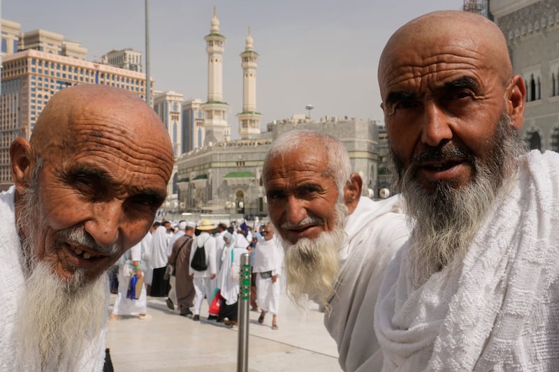 Afghan Hajj pilgrims wait outside the Grand Mosque, in Makkah, Saudi Arabia. AP