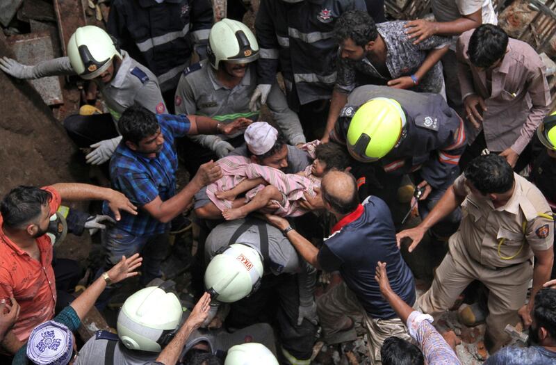 Rescue workers carry a child who was rescued from the rubble. Reuters