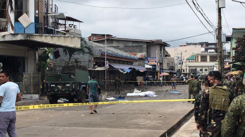 Filipino soldiers stand guard next to the covered bodies of victims in front of a church following explosions in Jolo city, Sulu, Philippines.  EPA