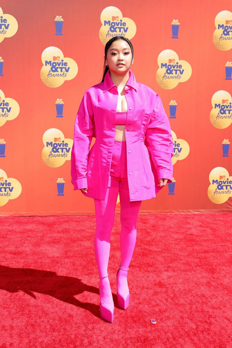 Lana Condor wearing a co-ordinated hot pink Valentino suit and crop top. AFP