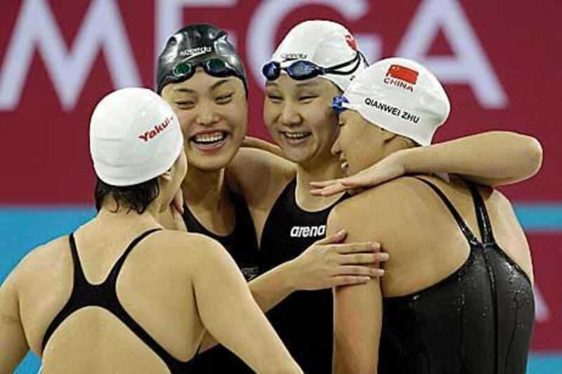 China's women's 4x200-metre freestyle relay team celebrate setting their world record in Dubai.